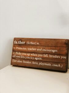 UnHappy Father’s Day — 10 Tips To Find Peace When Fatherhood Hurts 3 A wooden board defining the roles of father - Protector, Hero, Coach, Etc